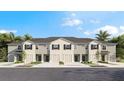 A stunning exterior view of the townhome community with landscaping and individual garages at 259 Royal Spoonbill Dr, Ruskin, FL 33570