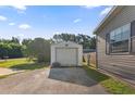 View of the garage and side of home showcasing additional storage and exterior details at 26438 Glenwood Dr, Wesley Chapel, FL 33544