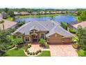 Beautiful lakefront home with mature landscaping, paver driveway, and neutral color palette in a desirable neighborhood at 3123 Whitehead Ln, Land O Lakes, FL 34638