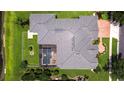 Aerial view of expansive roof, screened pool, and well-manicured landscaping in a verdant neighborhood at 3123 Whitehead Ln, Land O Lakes, FL 34638