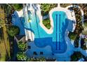 Aerial view of community pools showcasing a kid-friendly zone and lap lanes surrounded by lush landscaping at 33487 Azalea Ridge Dr, Wesley Chapel, FL 33545
