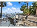 Inviting backyard space with a fire pit, seating area, and water views at 3800 Shore Acres Ne Blvd, St Petersburg, FL 33703