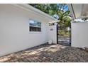 Charming courtyard with brick paving, privacy wall, and gated access at 3800 Shore Acres Ne Blvd, St Petersburg, FL 33703