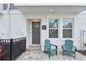 Inviting front porch with two Adirondack chairs, perfect for enjoying the neighborhood's charm at 448 31St N Ln, St Petersburg, FL 33713