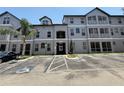 Three-story condominium building with parking; gray tone with painted white trim at 5048 Sunridge Palms Dr # 103, Tampa, FL 33617
