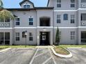 Three-story condominium building with parking; gray tone with painted white trim at 5048 Sunridge Palms Dr # 103, Tampa, FL 33617