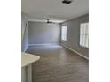 Spacious living room featuring wood-look floors and natural light through window blinds at 5101 Corvette Dr, Tampa, FL 33624