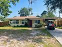 Charming single-story home with a well-maintained yard and convenient golf cart parking at 5805 Tennessee Ave, New Port Richey, FL 34652