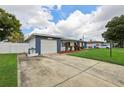 Single-story home featuring a well-kept lawn and spacious driveway at 6149 37Th N Ave, St Petersburg, FL 33710