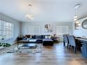 Open-concept living and dining area with modern furnishings and plenty of natural light at 6205 Chapel Pines Blvd, Wesley Chapel, FL 33545