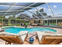 Inviting screened-in pool area with comfortable lounge chairs perfect for relaxing or entertaining guests at 734 Lake Forest Rd, Clearwater, FL 33765