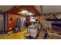 Rustic kitchen with stone fireplace, stainless steel appliances, and a unique backsplash at 7415 San Moritz Dr, Port Richey, FL 34668
