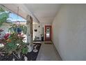 Welcoming front porch with decorative plants and a red front door at 7924 Singing Court Pl, Tampa, FL 33615