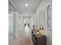 Inviting foyer showcasing neutral walls, tile flooring, and decorative accents at 8508 Bay Dr, Spring Hill, FL 34606