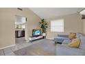 Inviting living room with tile floors, complemented by a sectional sofa and lots of light from the large window at 8708 Albion Ct, Tampa, FL 33634