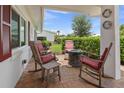 Relaxing covered outdoor patio with comfortable seating and fire pit for entertaining at 9226 41St N St, Pinellas Park, FL 33782