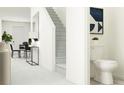 Hallway provides access to a staircase, bathroom, and living area creating a functional and inviting space at 10808 Keato Beach Ct, Tampa, FL 33647