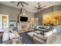 Covered patio with stone fireplace, comfortable seating, and ceiling fans, offering a relaxing outdoor space at 11441 Hammock Oaks Ct, Lithia, FL 33547