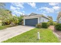 Attractive one-story home with a two-car garage, well-kept lawn, and lush landscaping at 11620 Crest Creek Dr, Riverview, FL 33569
