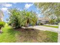 Landscaped front yard showcasing lush greenery and mature trees that adds a touch of nature to the property at 11620 Crest Creek Dr, Riverview, FL 33569