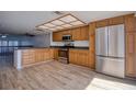 Open kitchen featuring wood cabinets, stainless steel appliances, and tile flooring at 128 1St Street E. # 102, Tierra Verde, FL 33715
