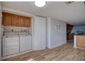 Convenient laundry room featuring a washer, dryer, and upper cabinets at 128 1St Street E. # 102, Tierra Verde, FL 33715