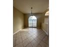 The dining room features ceramic tile floors, modern light fixtures, and large windows that fill the room with light at 13632 Deventer Ct., Hudson, FL 34667