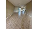 A bright living space features ceramic tile floors and leads to a backyard through sliding glass doors at 13632 Deventer Ct., Hudson, FL 34667
