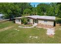 Charming single-story home with a rock detail, mature trees, and a well-maintained lawn at 2015 Pleasant Acre Dr, Plant City, FL 33566