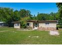 Charming single-story home with a rock detail, mature trees, and a well-maintained lawn at 2015 Pleasant Acre Dr, Plant City, FL 33566