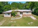 Charming single-story home with a rock detail, mature trees, and a well-maintained lawn at 2015 Pleasant Acre Dr, Plant City, FL 33566