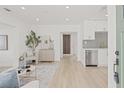 Bright, open-concept living space with light wood floors and modern decor at 3008 W Van Buren Dr, Tampa, FL 33611
