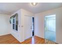 Inviting foyer with wood-look flooring, window, and access to other rooms at 3053 Gregor Ct, Palm Harbor, FL 34684