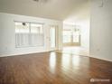Bright living room with laminate floors and ample natural light at 3095 Coronet Ct, Spring Hill, FL 34609
