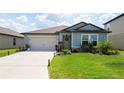 Beautiful single-Gathering home featuring a well-manicured lawn and a spacious two-car garage at 3611 Natural Trace St, Plant City, FL 33565