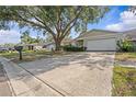 Charming single-story home featuring a two-car garage, mature landscaping, and a well-maintained lawn at 4120 Tyndale Dr, Brandon, FL 33511