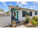 Inviting front entrance with teal door, decorative metal porch posts, and a cozy seating area at 4226 4Th S Ave, St Petersburg, FL 33711