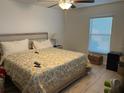 Cozy bedroom featuring a comfortable bed with a patterned comforter and natural light from a window at 4433 Eternal Prince Dr, Sun City Center, FL 33573