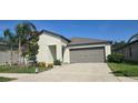 Well-maintained home featuring a two-car garage and manicured landscaping in a suburban neighborhood at 4433 Eternal Prince Dr, Sun City Center, FL 33573