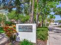 Beautiful Audubon Park community sign surrounded by lush landscaping and mature trees at 4702 W Heron Ln, Tampa, FL 33629