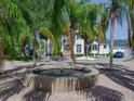Stunning fountain situated among palm trees highlighting the beauty of the home's curb appeal at 4702 W Heron Ln, Tampa, FL 33629