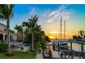 Waterfront property with a private dock, boat lift, and stunning sunset views over the bay at 514 Riviera Dr, Tampa, FL 33606