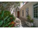 Inviting front entrance with stone steps, detailed archway, and lush landscaping creating curb appeal at 514 Riviera Dr, Tampa, FL 33606