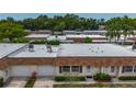 Aerial view of home showing roof, garage, and surrounding trees in established neighborhood at 602 Mindy Dr, Largo, FL 33771
