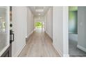 Inviting entryway featuring wood-look floors and plenty of natural light creates a warm atmosphere at 6126 Hidden Branch Dr, Apollo Beach, FL 33572
