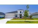Attractive home with vertical siding, stone accents, black trim, and fresh landscaping enhancing curb appeal at 6126 Hidden Branch Dr, Apollo Beach, FL 33572