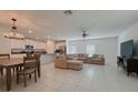 Spacious open-concept living room and kitchen with modern decor and plenty of natural light at 6444 Bar S Bar Trl, Zephyrhills, FL 33541