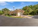 Townhome with a two-car garage, tile roof, and manicured landscaping at 7246 Gaberia Rd, New Port Richey, FL 34655