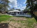 Large backyard featuring a new patio and screened in pool with fresh landscaping at 7278 Radcliff St, Spring Hill, FL 34606