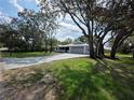 Attractive single-story home with long driveway, lush front lawn and mature landscaping at 7278 Radcliff St, Spring Hill, FL 34606